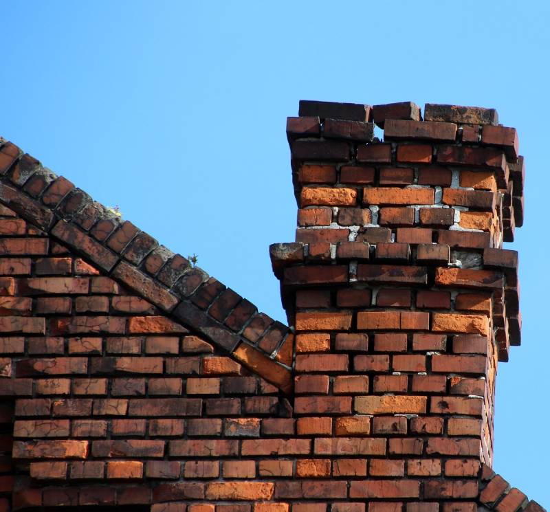 Signs Your Bartlett Home Needs a Chimney Inspection Damaged chimney on an Bartlett home showing cracks and missing mortar